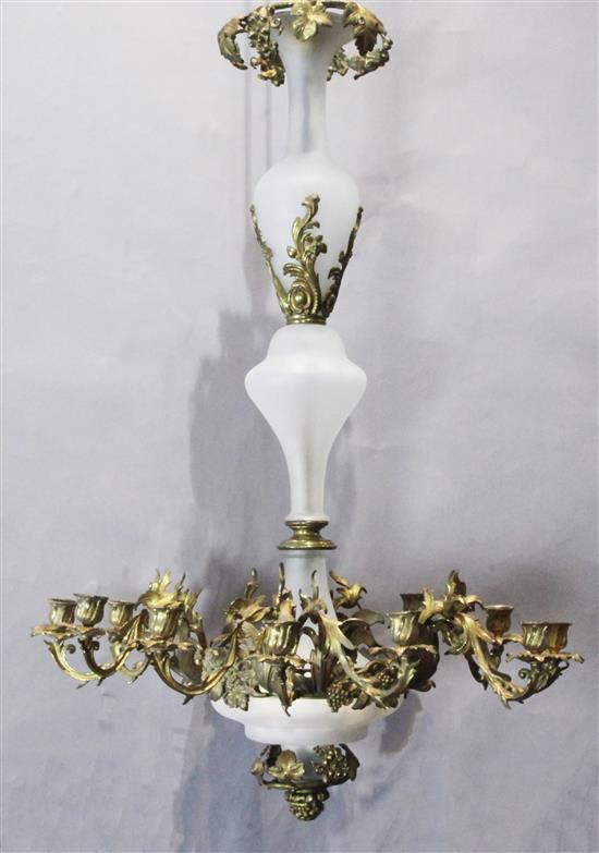 A 19th century French gilt metal and opaque glass twelve light chandelier, drop 3ft 1in. diameter 2ft 2in.
